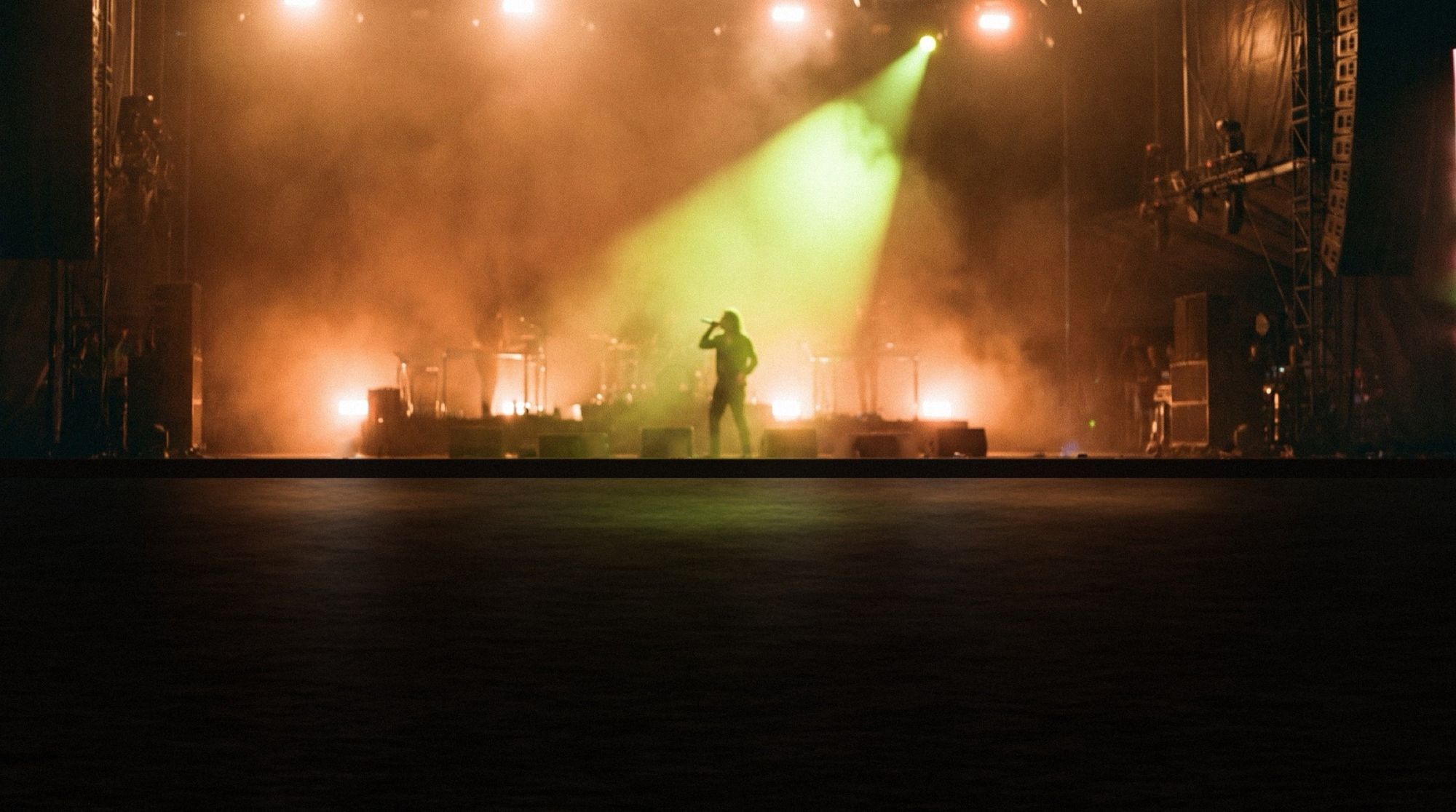 Illustration: the ground in front of a stage, empty.